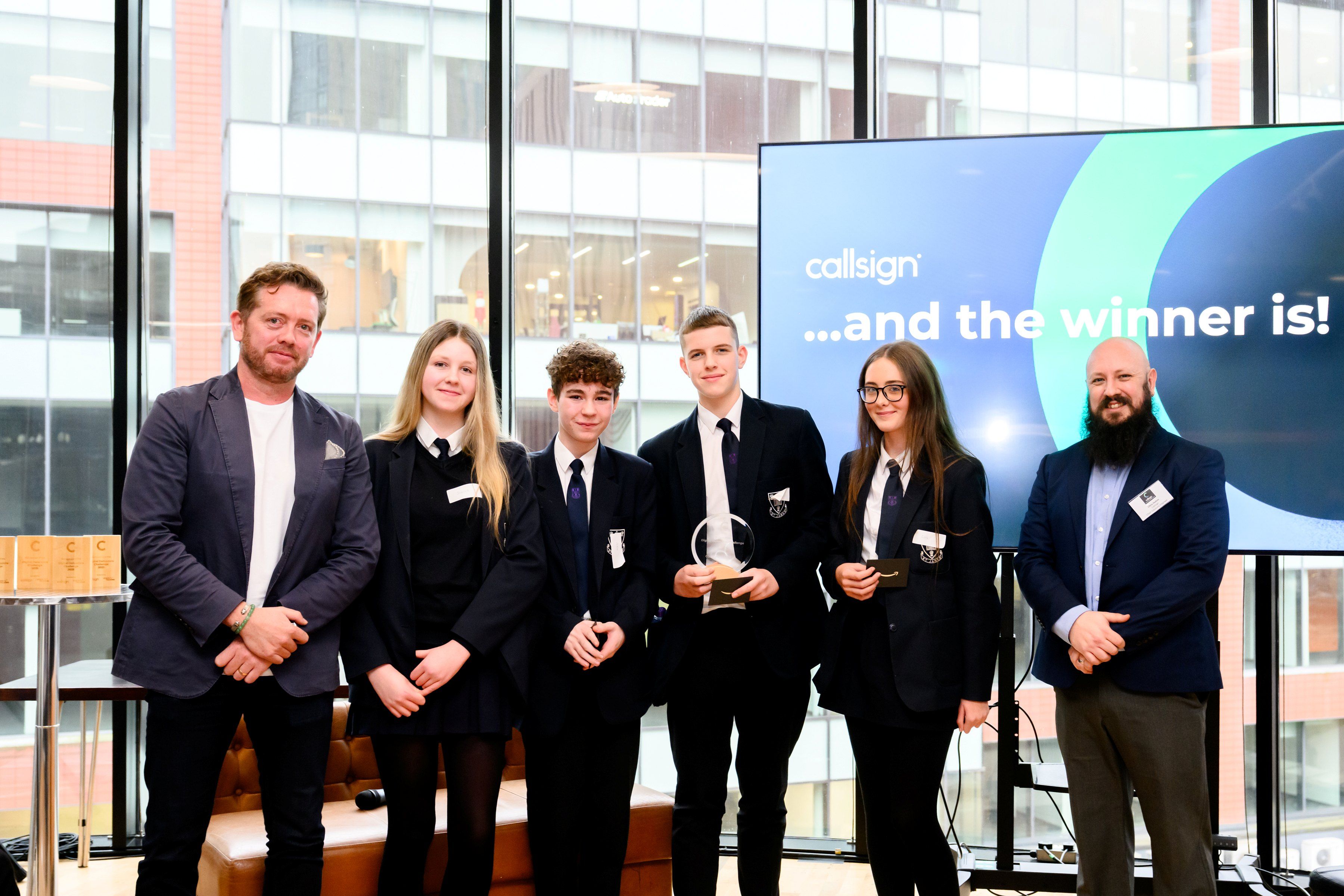 l-r Senan Moloney, CTO, Callsign, winning students Scarlett, Jaxon, Charlie and Cora and Chris Hutton, VP of customer integration, Callsign