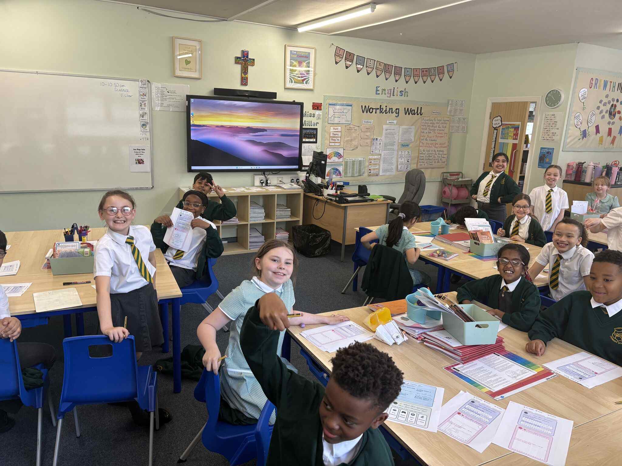 A classroom of smiling primary aged children